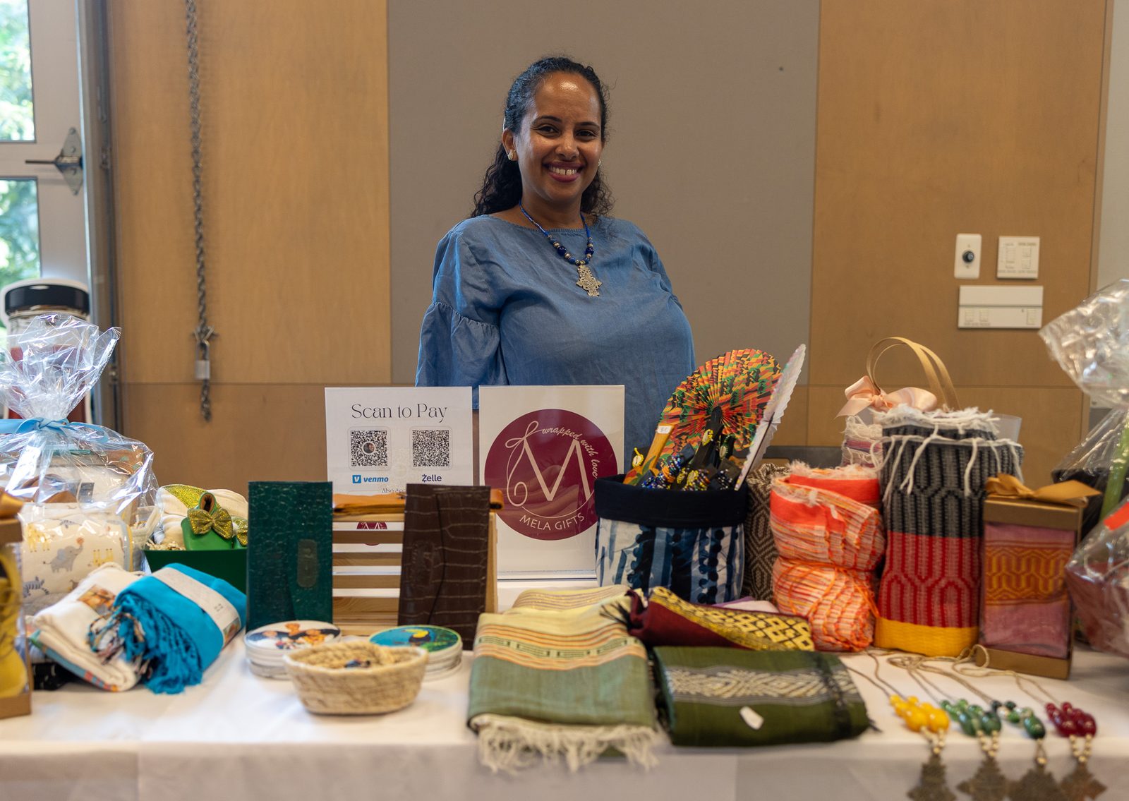Textiles, soaps, and a full table. MELA Gifts.