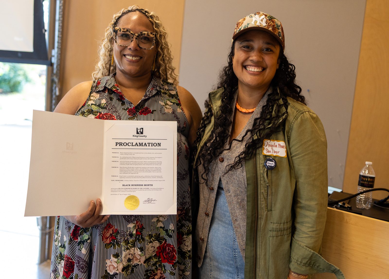 Katoya Palmer and Angela Phan with the King County proclamation. King County Executive's Office.